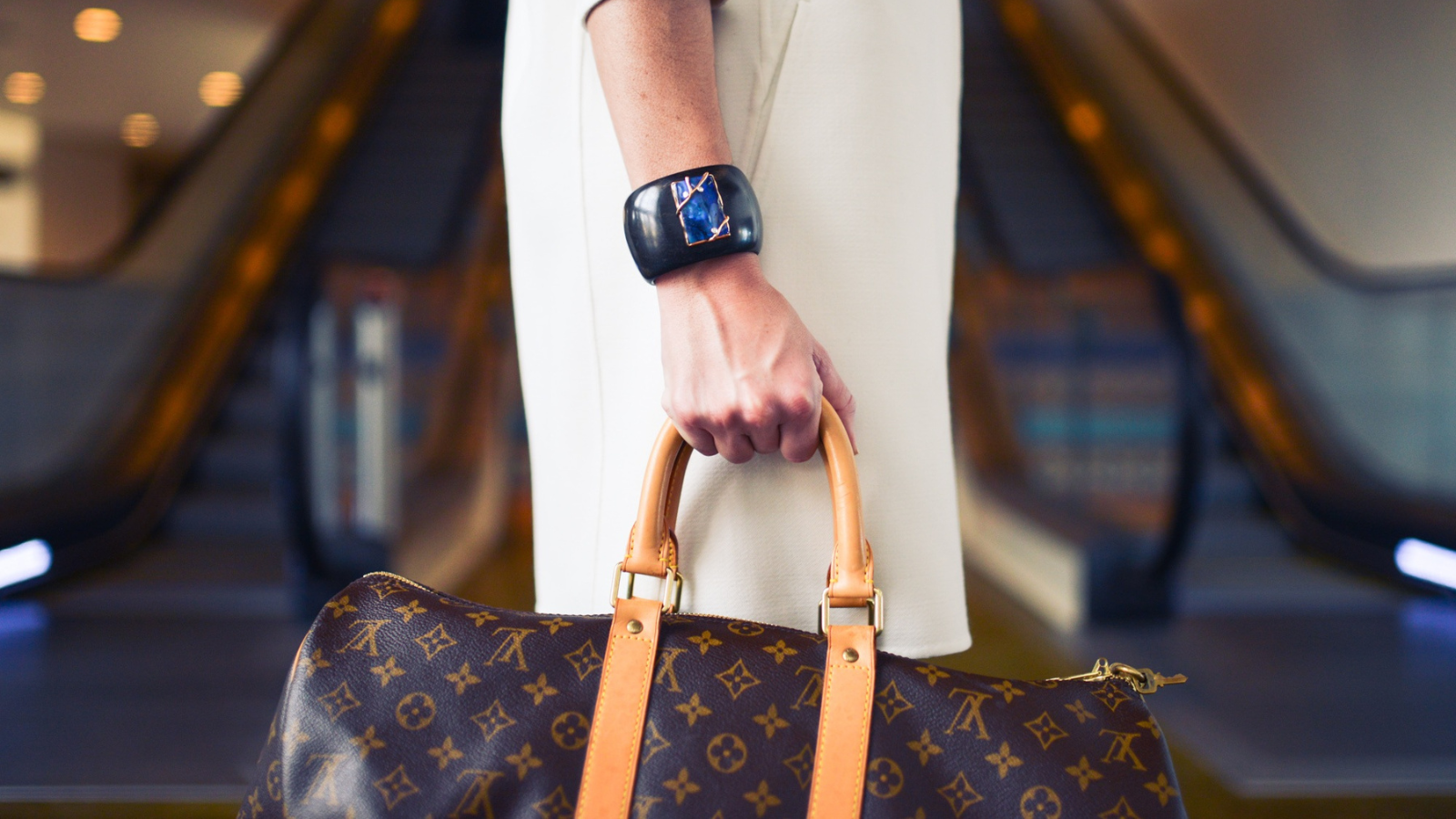 Woman carrying a designer bag for travel